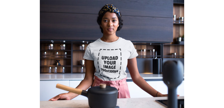 Woman in Kitchen wearing a T-Shirt Mockup Generator